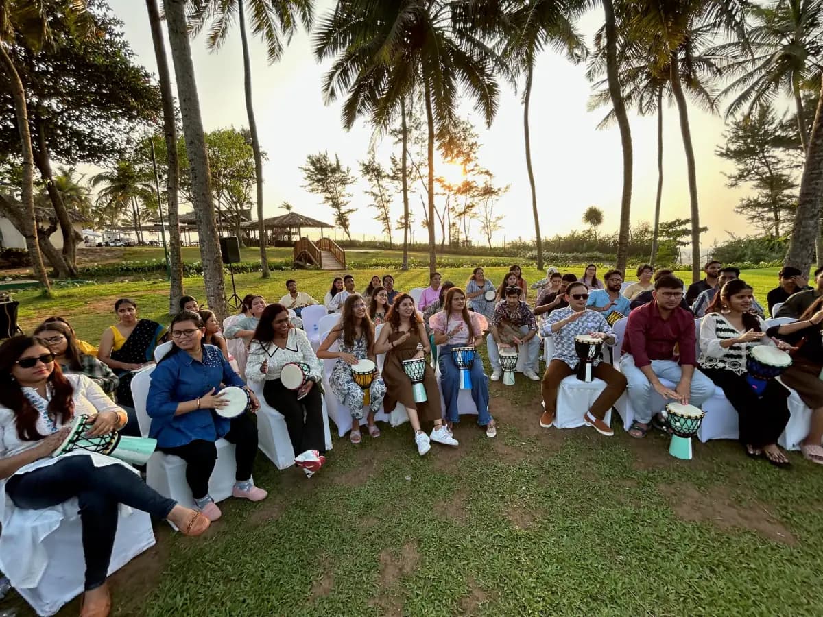 Colleagues taking part in an outdoor rhythm activity